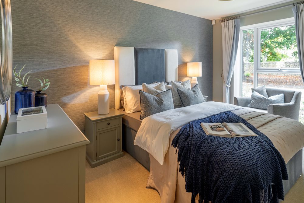a bedroom with a bed and a lamp