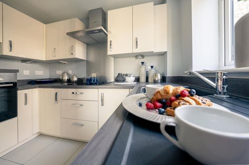 a kitchen with a bar and chairs