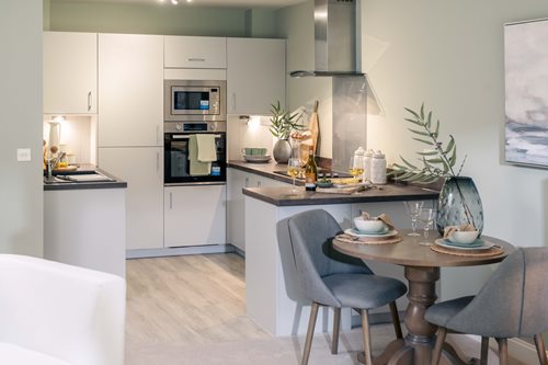 a kitchen with a table and chairs