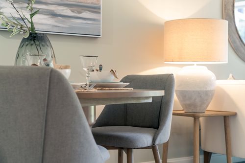 a table with chairs and a lamp