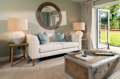 a living room with a white couch and a mirror
