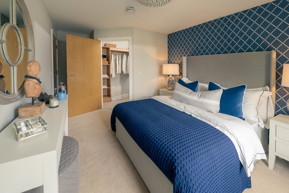 a bedroom with a bed and a mirror