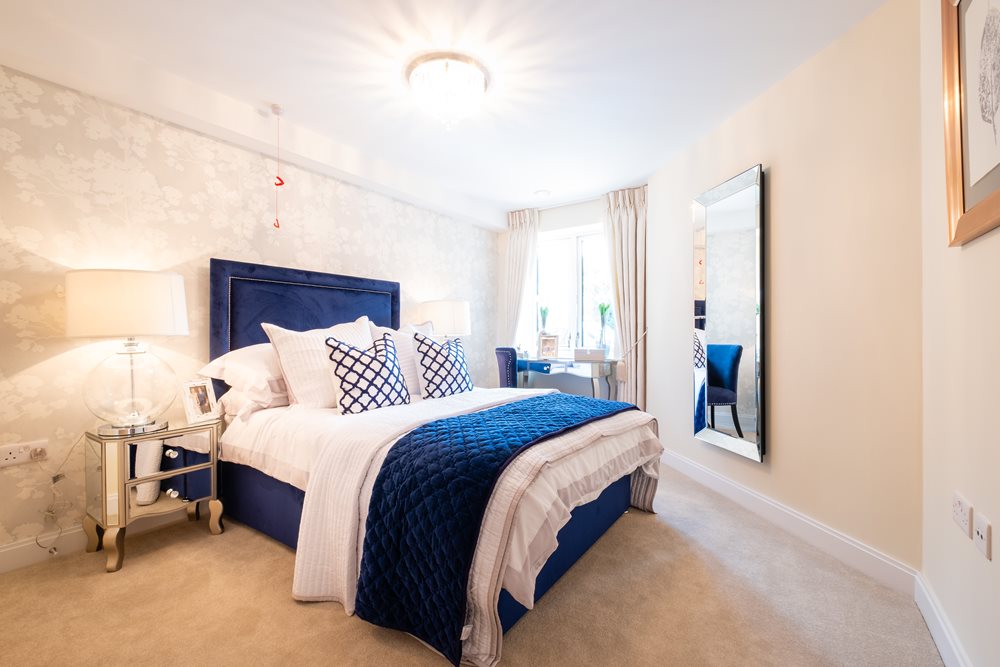 a bedroom with a bed and a mirror