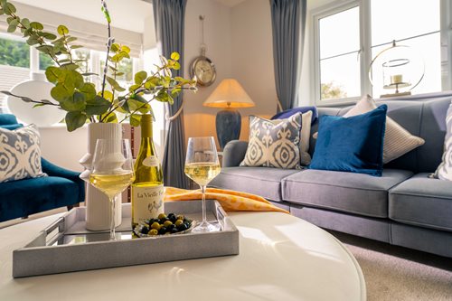 a table with wine glasses and a bottle of wine on it