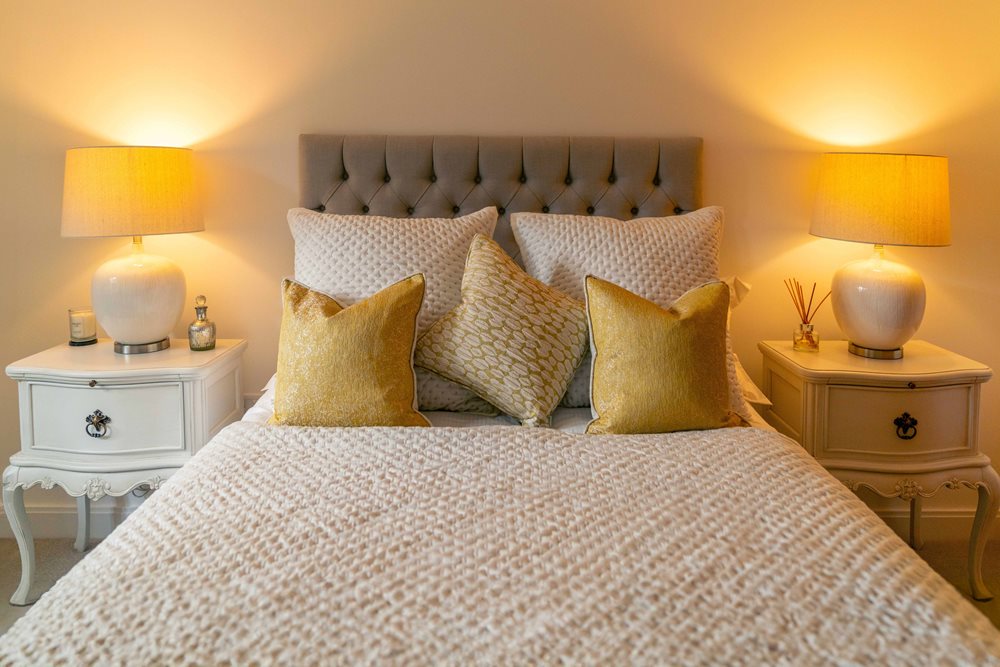 a bed with lamps on either side