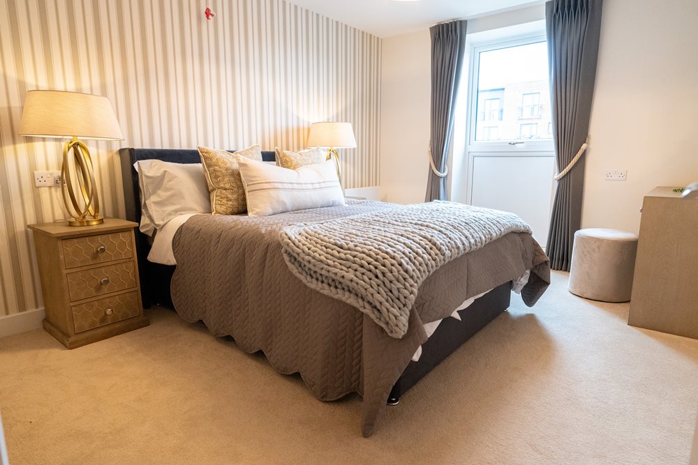 a bed with lamps and a window