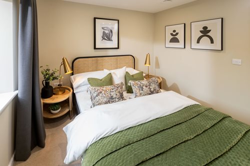 a bed with a green blanket