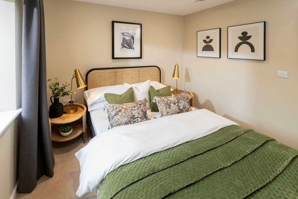 a bed with a green blanket