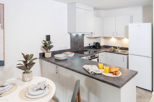a kitchen with a table and chairs