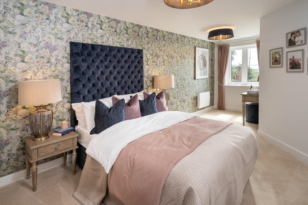 a bedroom with a bed and lamps