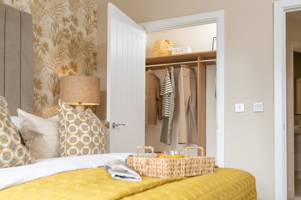 a bed with a yellow bed spread