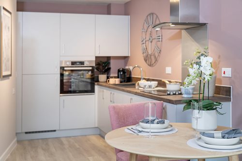 a kitchen with a table and chairs
