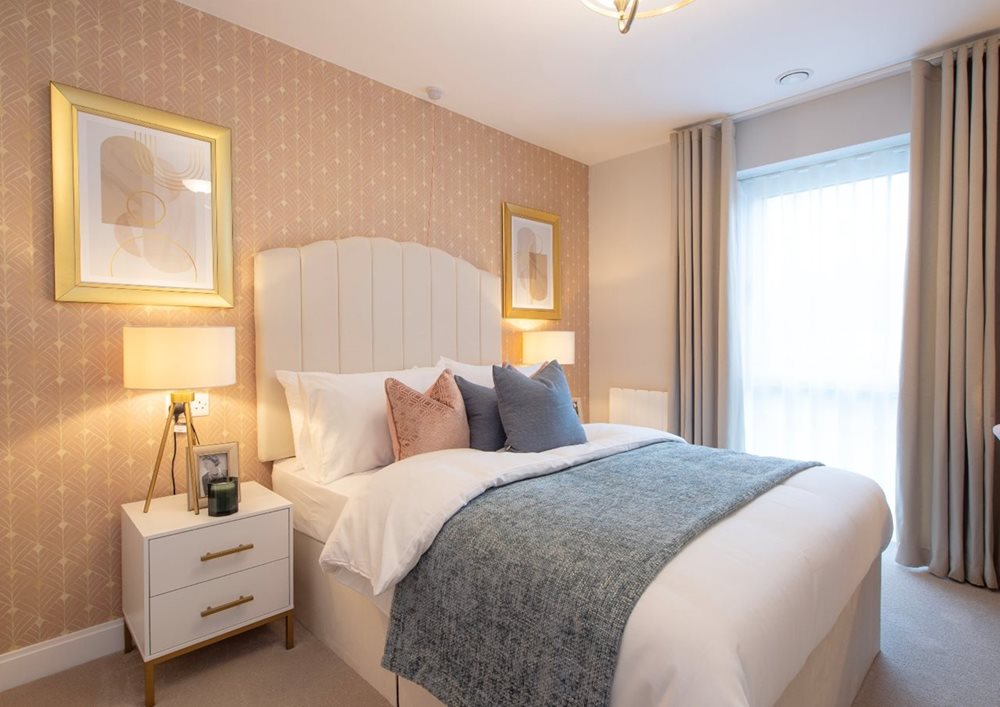 a bedroom with a bed and lamps