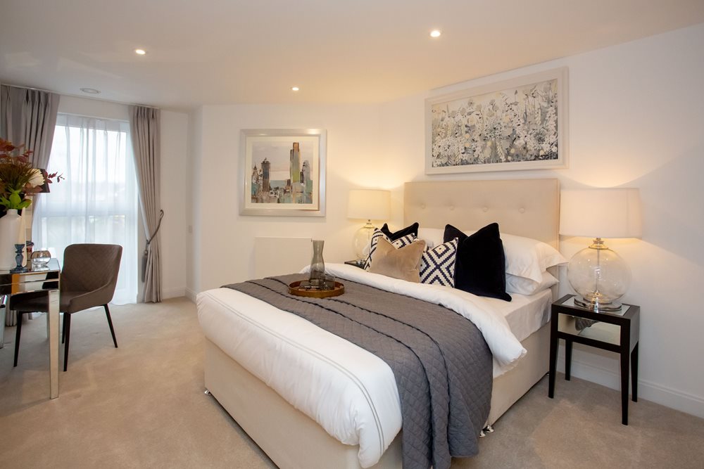 a bedroom with a bed and chairs