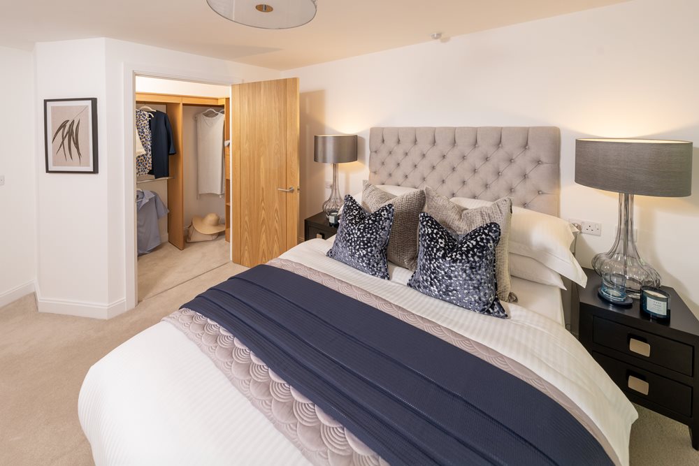 a bed with lamps either side