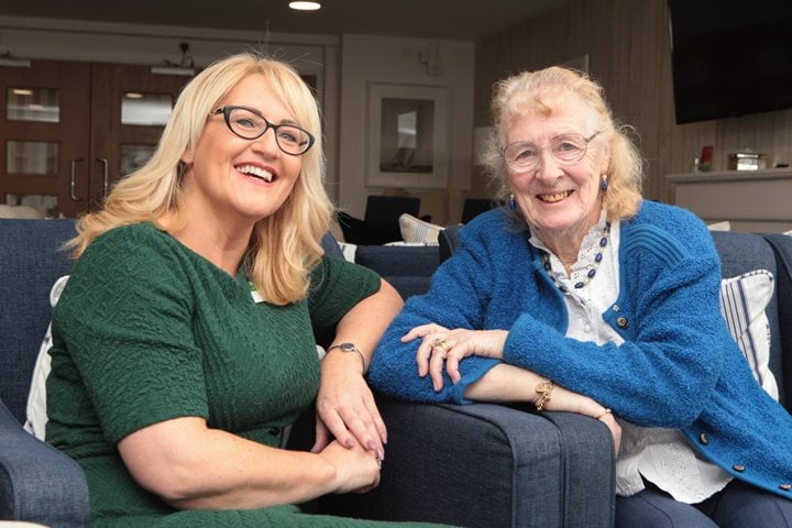 a couple of women sitting on a couch