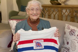 an old woman holding a flag