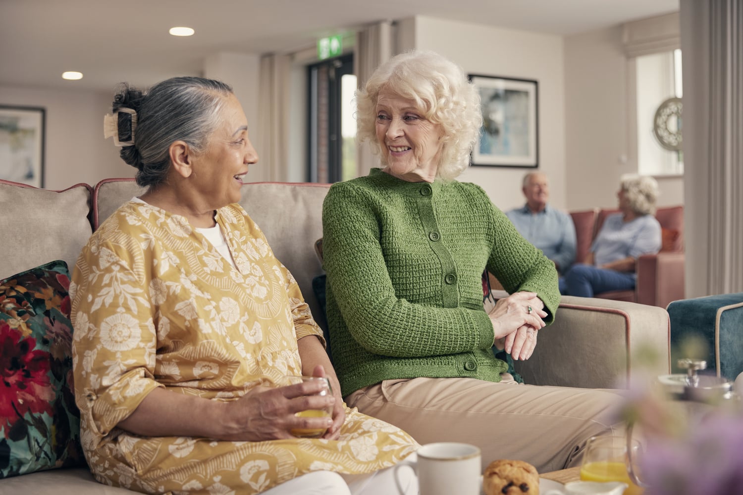 a couple of women sitting on a couch