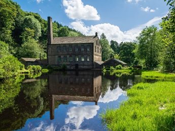 a house on a hill by a pond