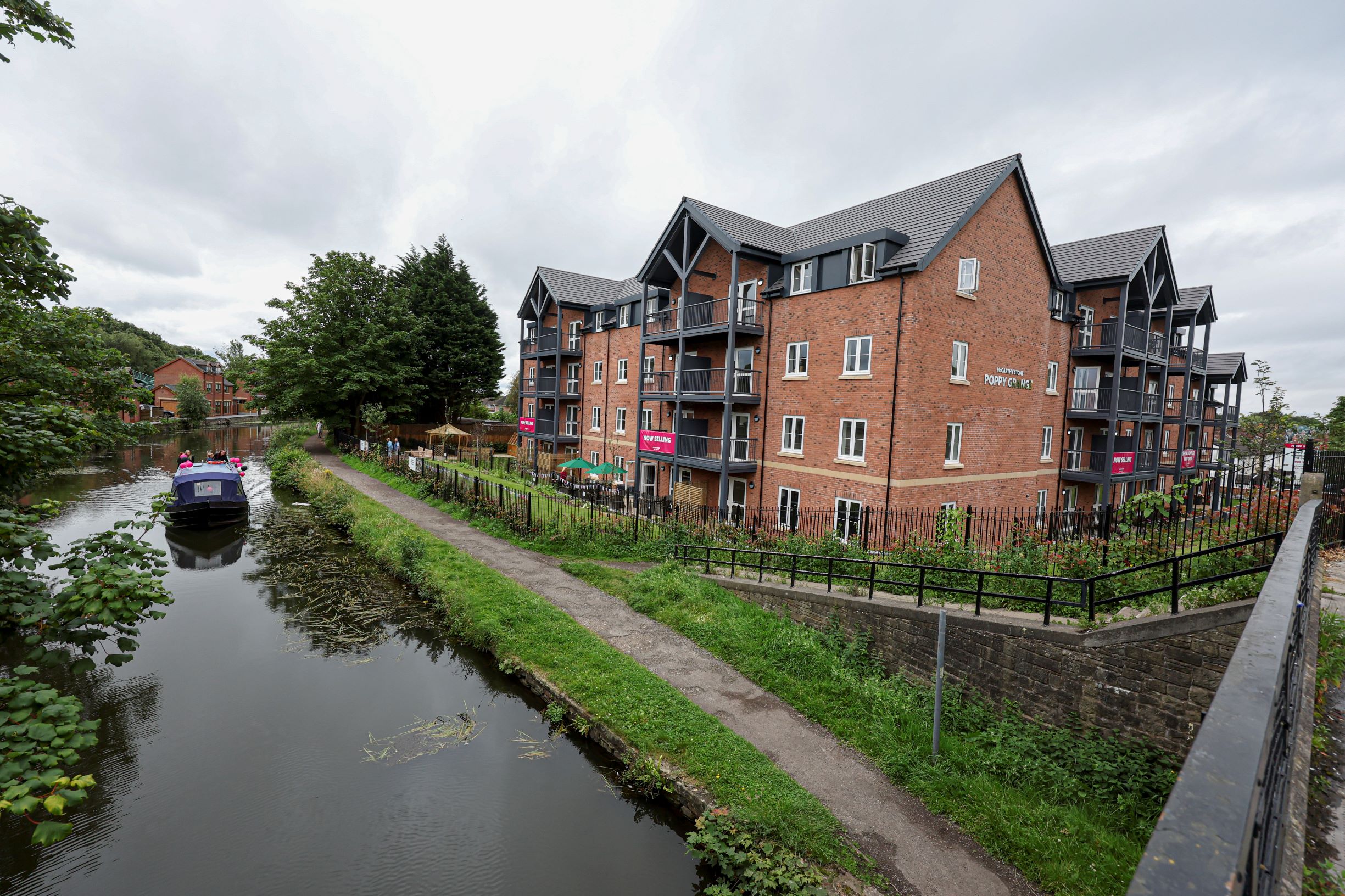 a canal with a boat in it and buildings along it