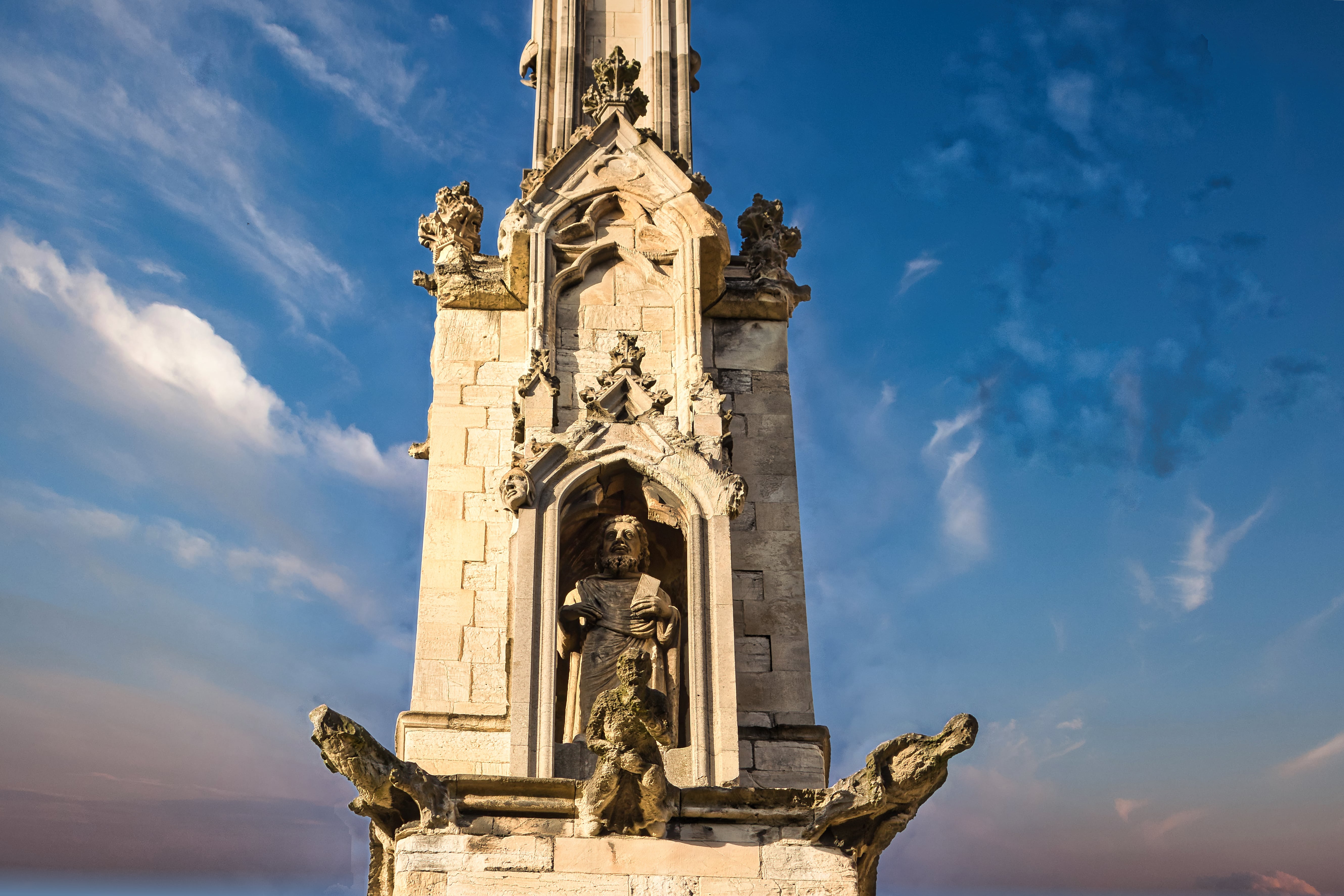 a tall stone tower with statues