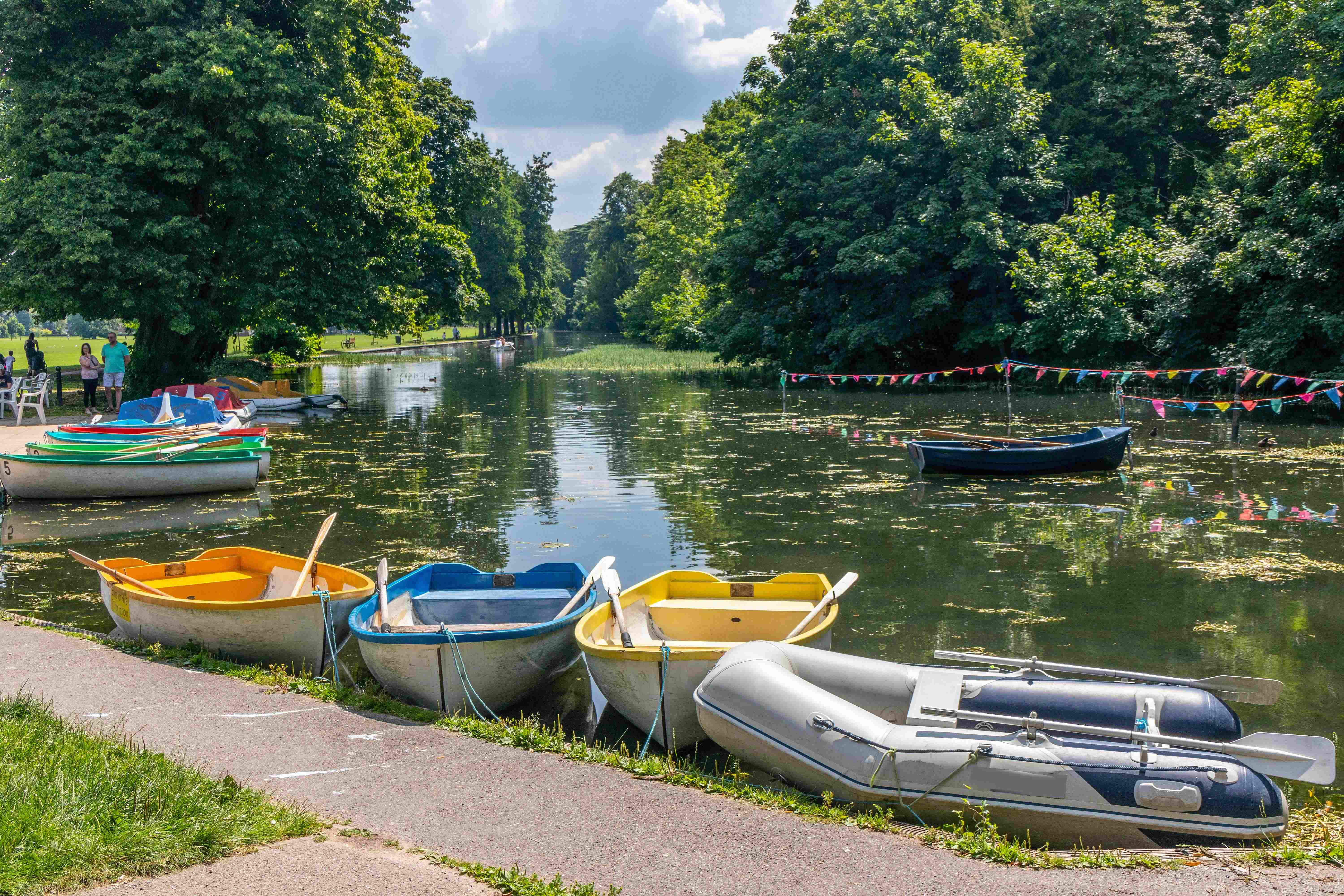 a group of boats sit on the side of a river
